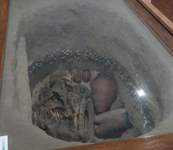 Reconstruction of a Predynastic burial at the Oriental Institute Museum (acc. no. OIM 11488). The burial pit would have been covered with an earthen mound the was the precursor of the mastaba superstructure. Photo by Anne Snyder Payne.