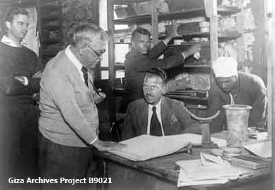 Harvard Camp, Giza offices; from left to right: Frank O. Allen, George Reisner, Nicholas Melnikoff, Hansmartin Handrick (seated), and Mohammed Said Ahmed (rephotograph from Al-Mussawar Arabic magazine, no. 740, December 16, 1938); January 4, 1939 (Giza Archives Project B9021)